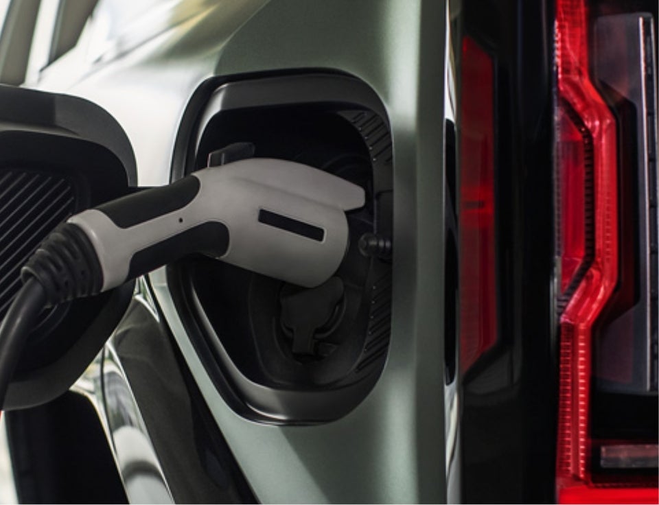 Close up of charging port with charger plugged in on a GMC Hummer EV SUV - Gold Star GMC in Salinas CA